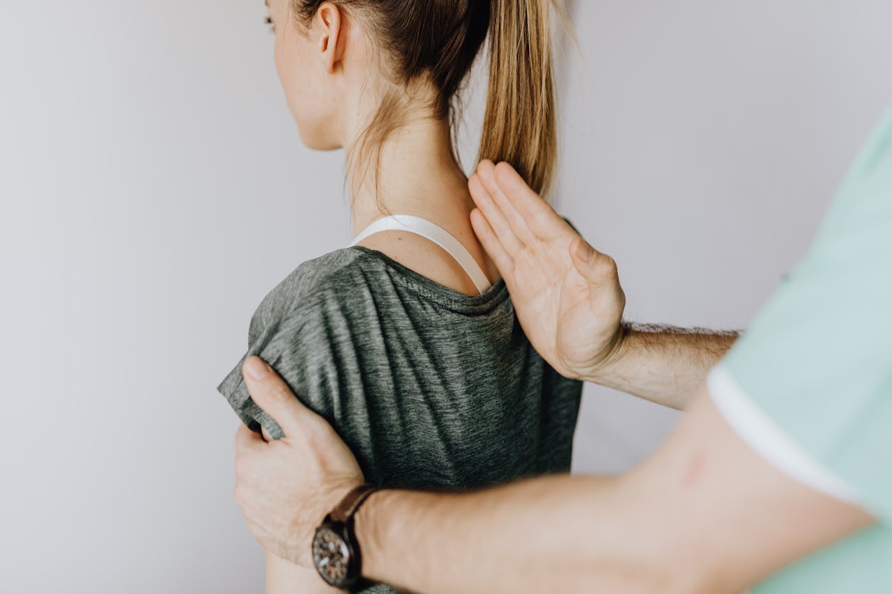 A chiropractor examining the spine of a woman